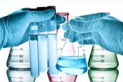 lab-technician-beakers-chemicals-gloves
