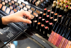 cosmetics display with consumer choosing lipstick