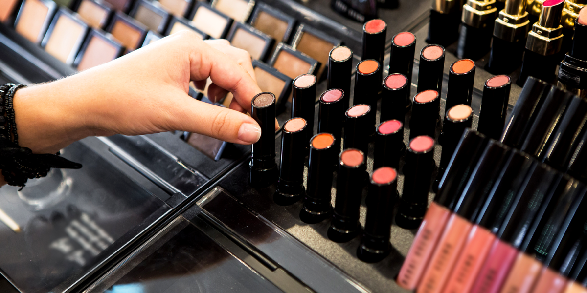 cosmetics display with consumer choosing lipstick