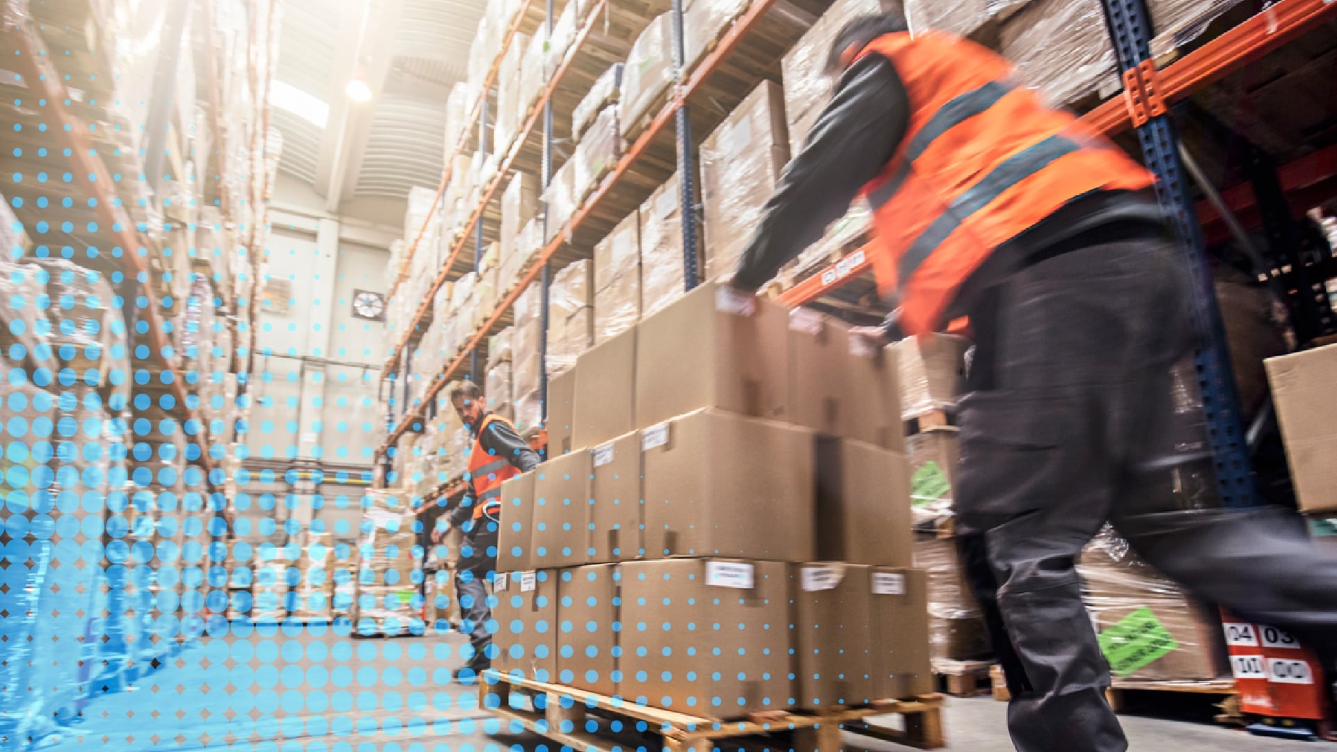 Worker pushing boxes through a warehouse