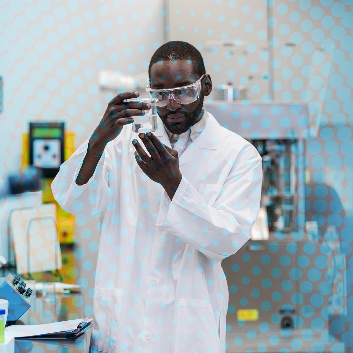 Researcher evaluates beaker of liquid substance