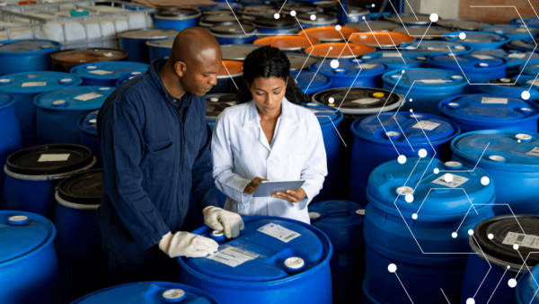 Workers at chemical facility reading tablet