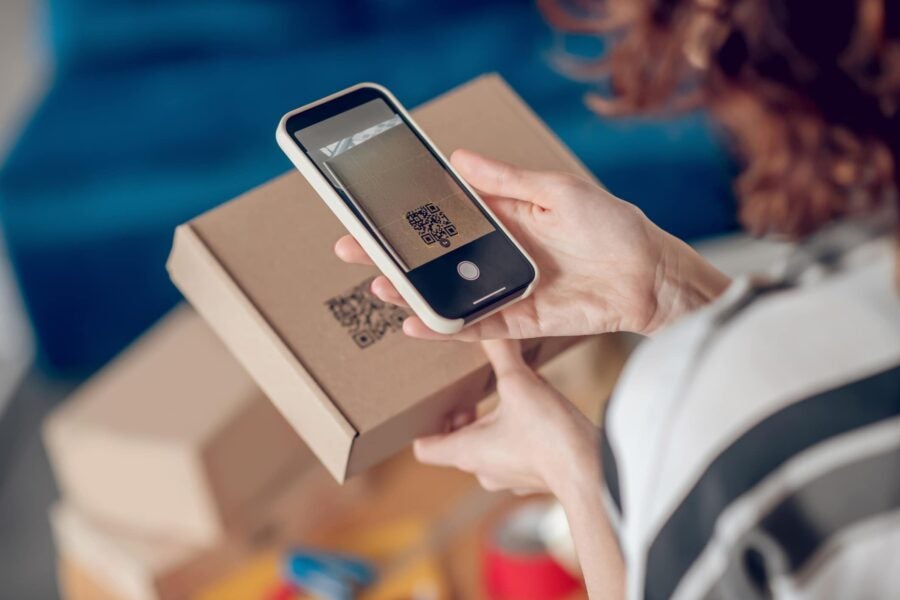 worker scanning information on the product package