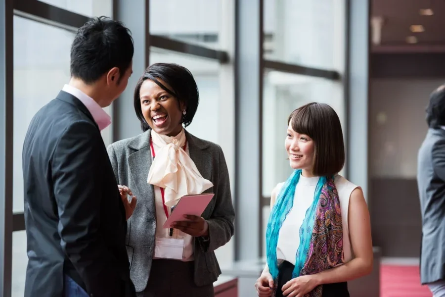 Multi ethnic business team consultng during a break at a conference