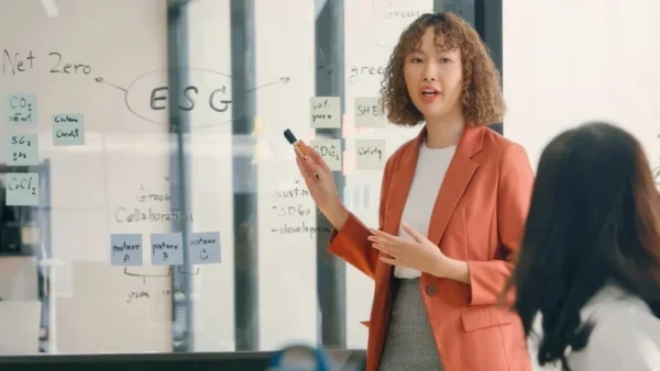 Woman leading sustainability meeting at company